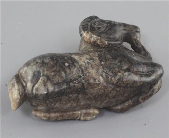 A Chinese grey and black mottled jade figure of a recumbent ram, 18th / 19th century, length 6cm